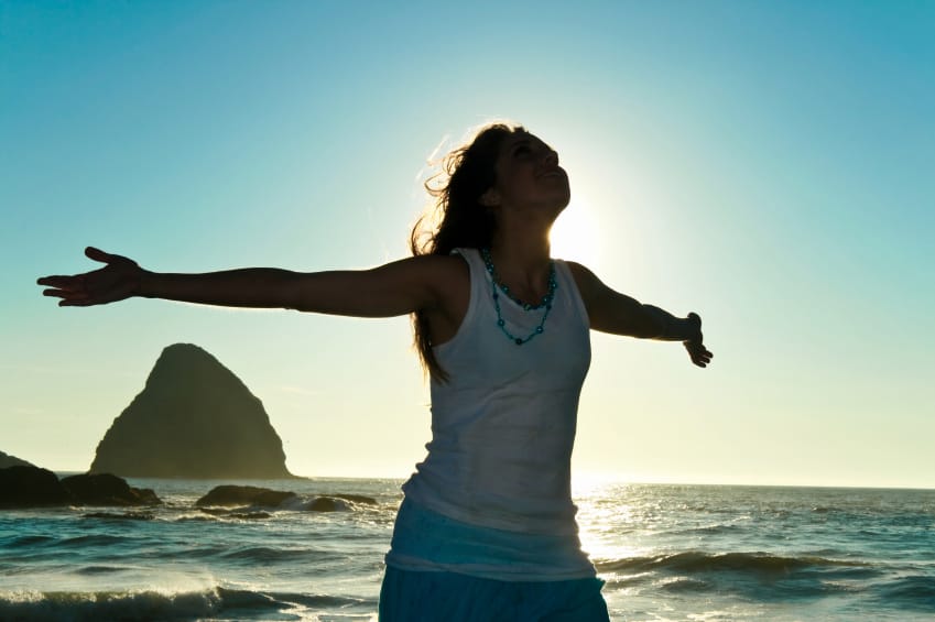 Woman with open arms and hands, face toward sky, a way to heal bad posture and depression