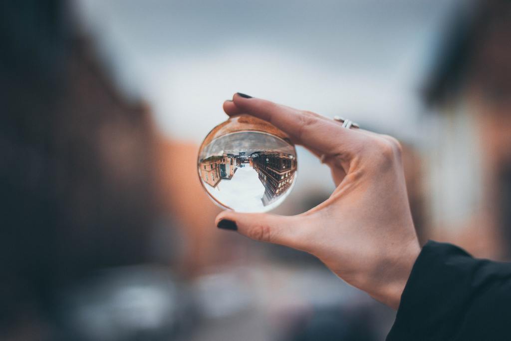 woman holding glass orb, perspective