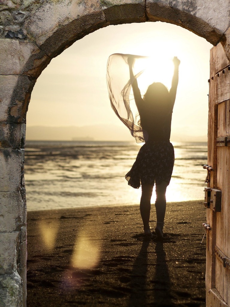 woman going hrough a door and entering a new reality