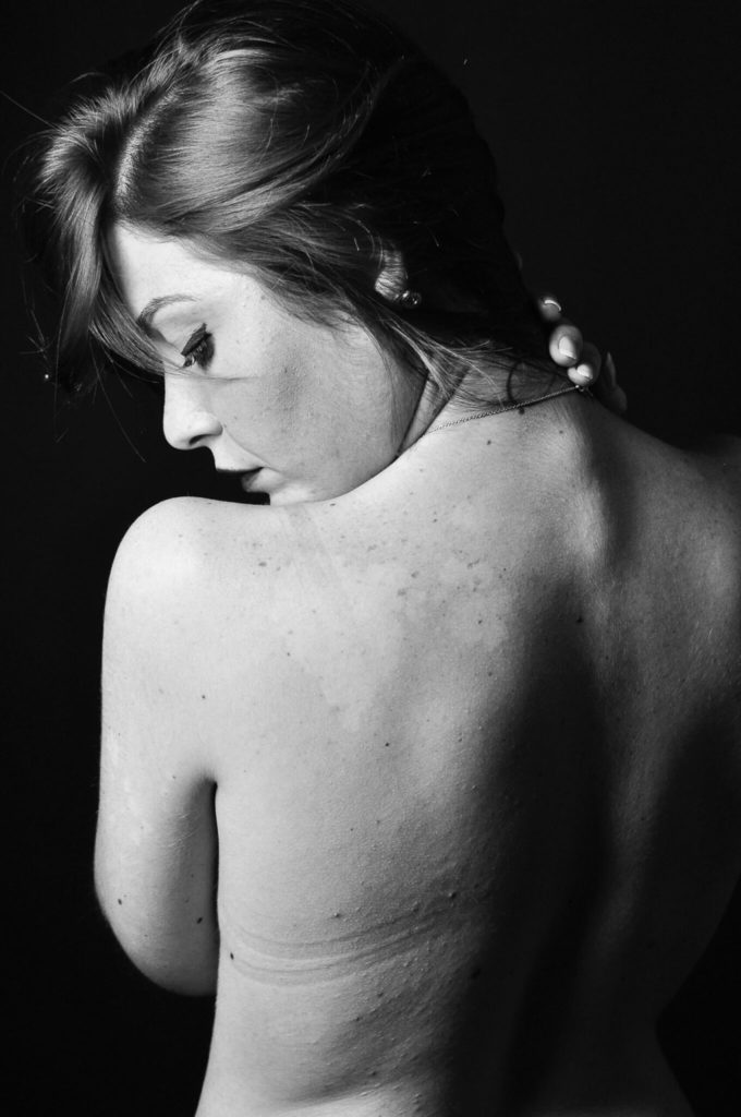 women holding back of neck