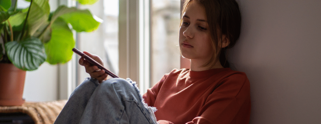 A lonely sad woman sitting alone in her room
