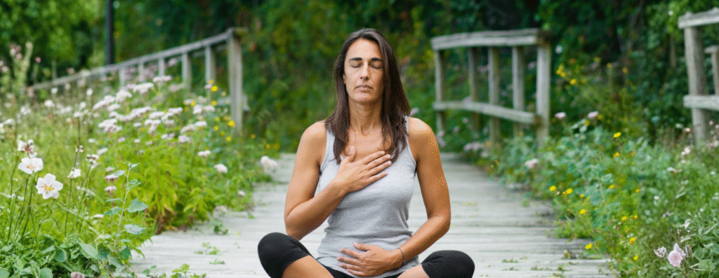 A woman meditating in a forest