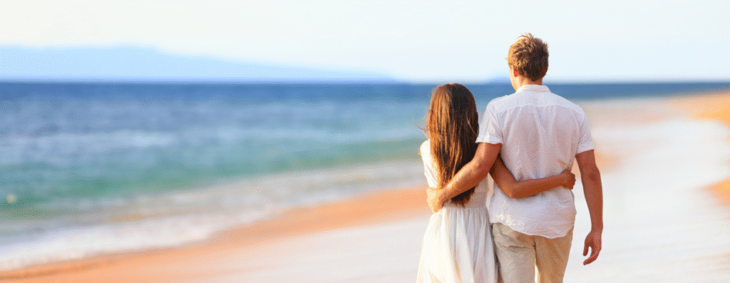 A couple hugging each other while walking