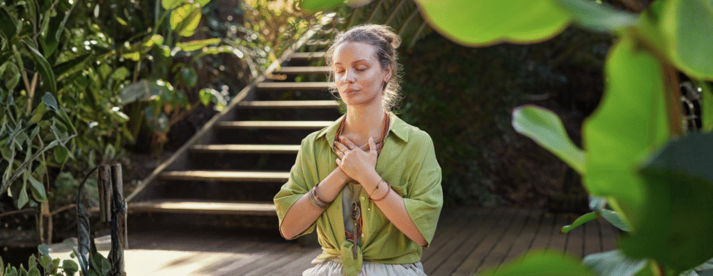 A woman meditating in a garden