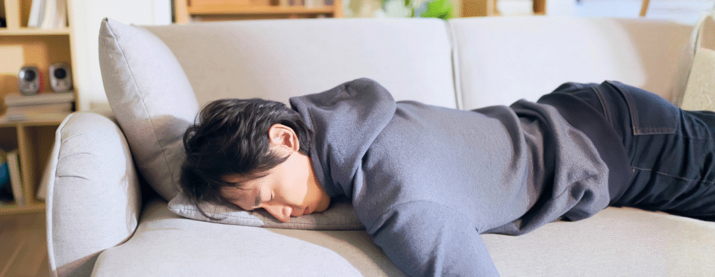 a man laying down and feeling exhausted