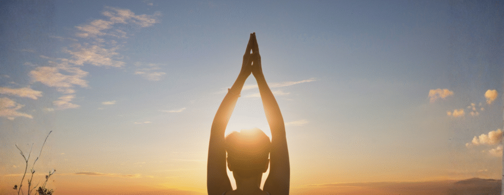 A man doing yoga facing the sunlight