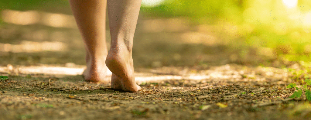 A man walking barefoot on the ground