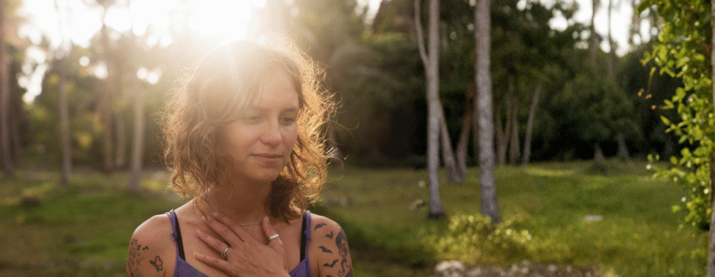 A woman meditating and doing breathwork for somatic embodiment