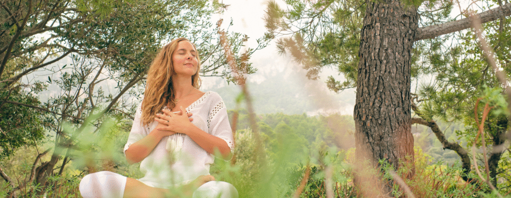 A woman meditating in the forest